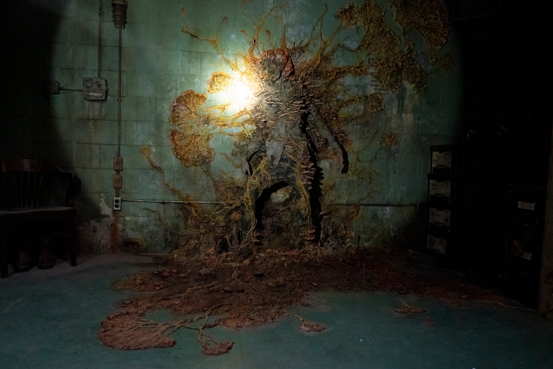A scene from the show showing Cordyceps fungus growing out of the body of a human it has infected.