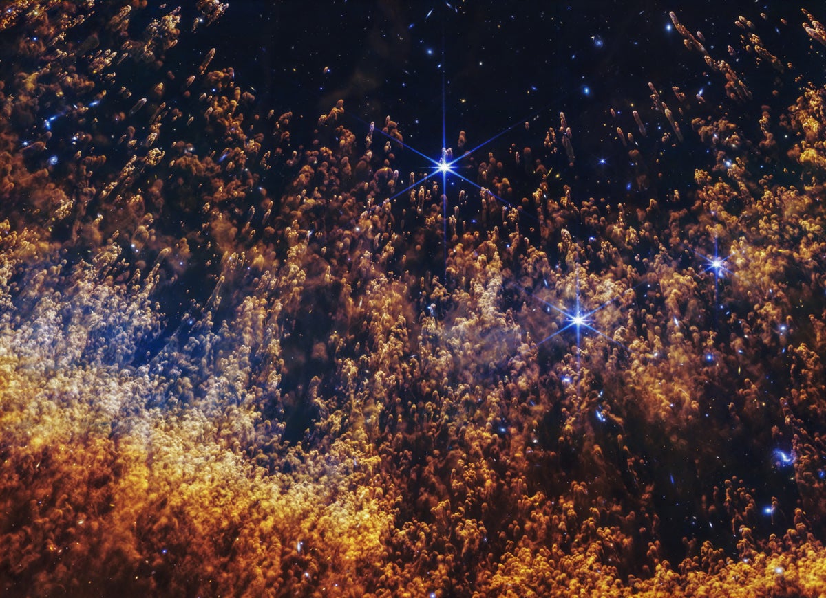 A colorful close-up of whorls and tendrils of gas and dust in the Helix Nebula