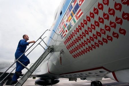 A person climbs the steps to one of the hurricane hunter planes.