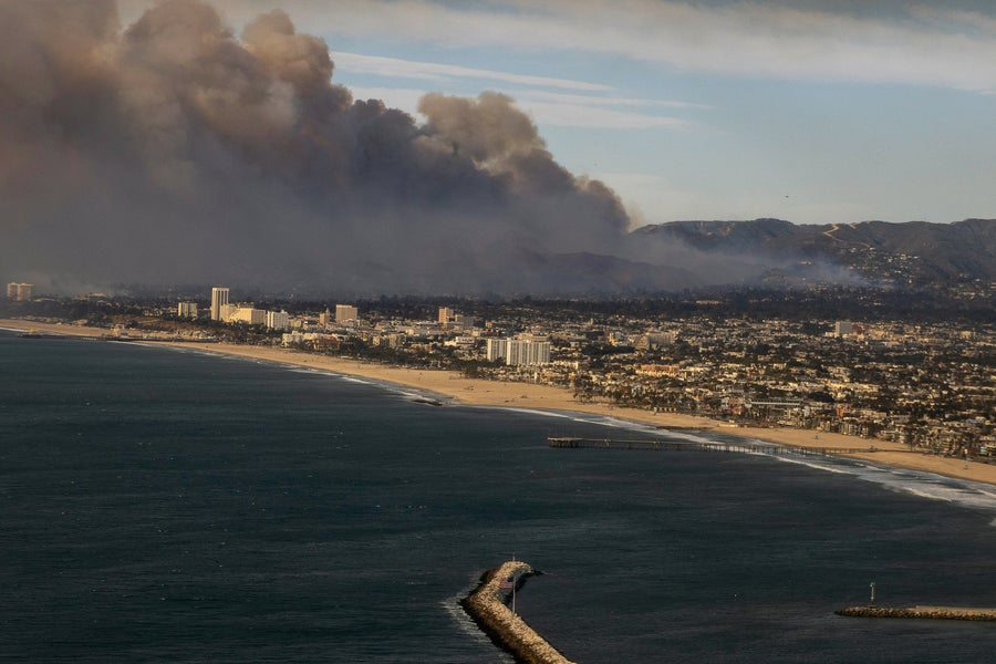 Smoke from the Palisades Fire is seen during a commercial flight flying over the ocean towards Los Angeles, California, Wednesday January 8, 2025