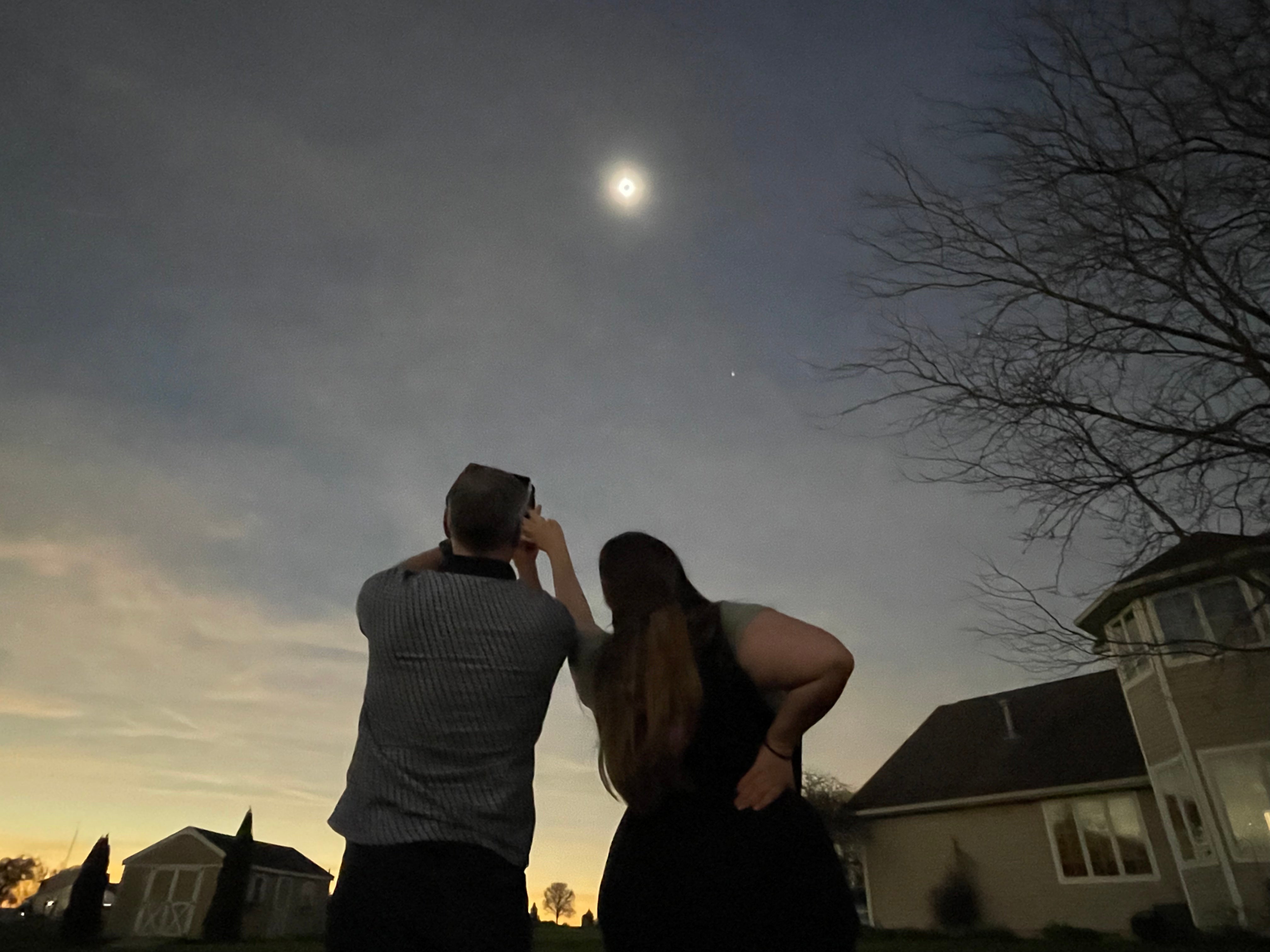 Two people watching a total solar eclipse