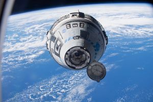 Boeing’s Starliner approaching the International Space Station as it flies 268 miles above the South Pacific, which is seen in the background.