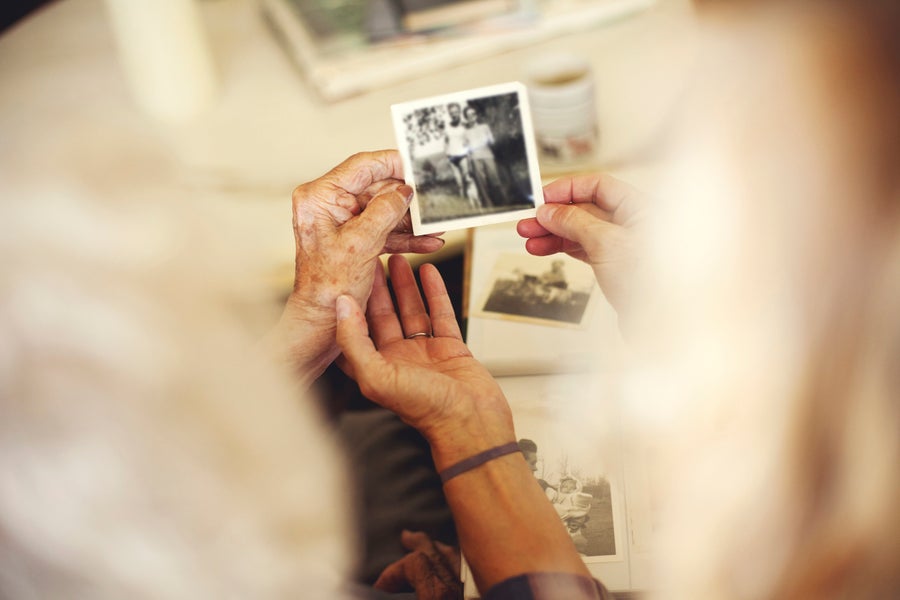 Two hands holding an old photograph