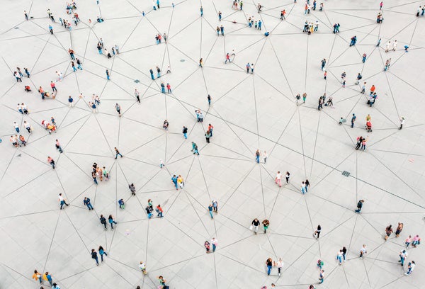 Aerial image of multiple people standing in clusters, connected by black lines.