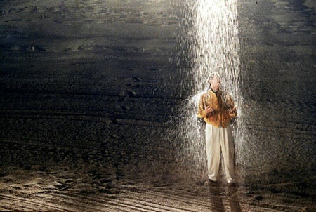 The Truman show film still with Jim Carrey standing under rain shower