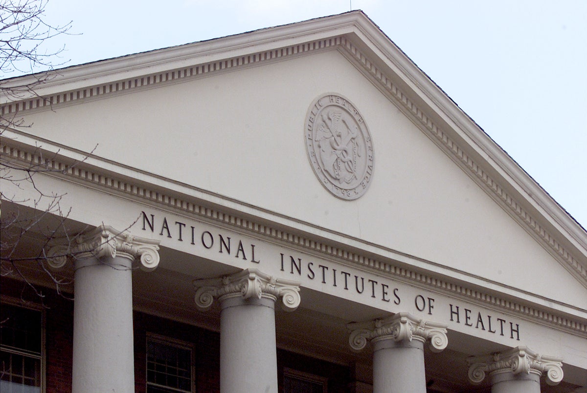 A columned building front topped by a triangular pediment reading National Institutes of Health