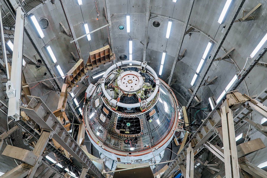 A spacecraft shown inside a metallic industrial structure.