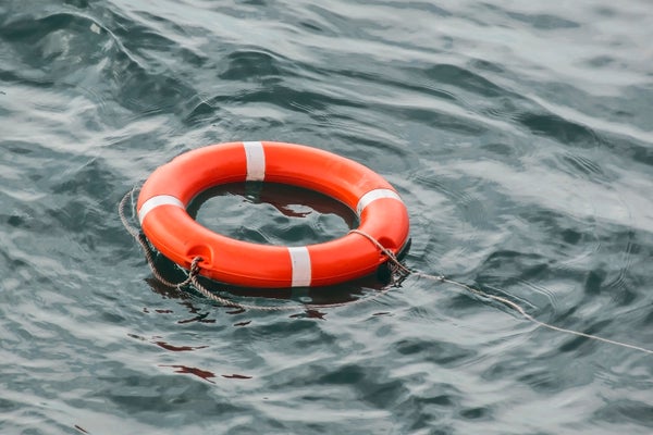 Bright orange life preserver floating in water