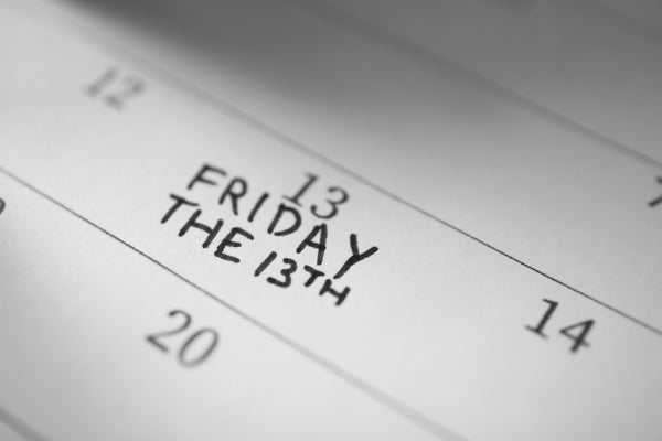 Calendar page with phrase Friday The 13th, closeup.