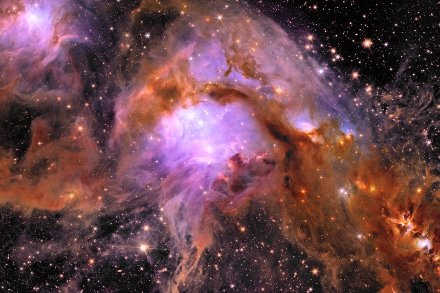 A filamentary orange veil covers a bright region of star formation. The background is dark, stippled with stars and galaxies ranging from small bright dots to starry shapes. The foreground veil spans from upper left to the bottom right and resembles a seahorse. Bright stars light up the ‘eye’ and ‘chest’ regions of the seahorse with purple light. Within the tail, three bright spots sit in a traffic-light like