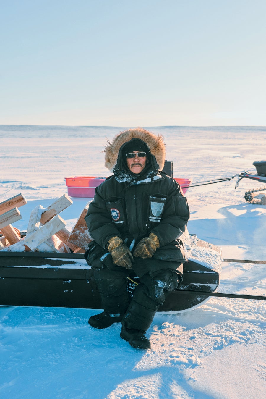 Man sitting on equipment in the Arctic