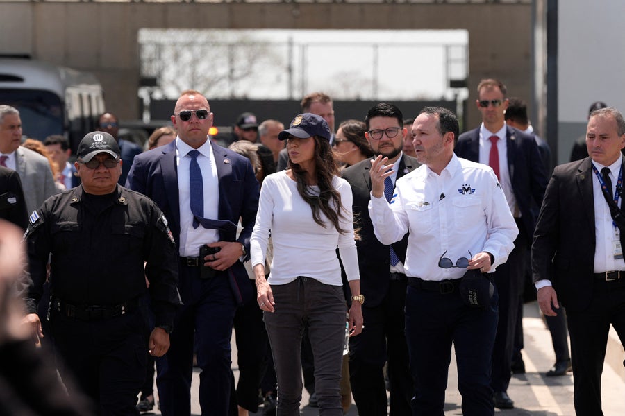 El Salvador's Minister of Justice and Public Security Gustavo Villatoro (2R) accompanies US Homeland Security Secretary Kristi Noem (C) during a tour of the Terrorist Confinement Center (CECOT) in Tecoluca, El Salvador, March 26, 2025.