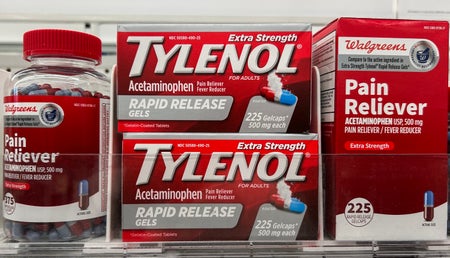 Two boxes marked Tylenol, a pill bottle and a generic box on a shelf.