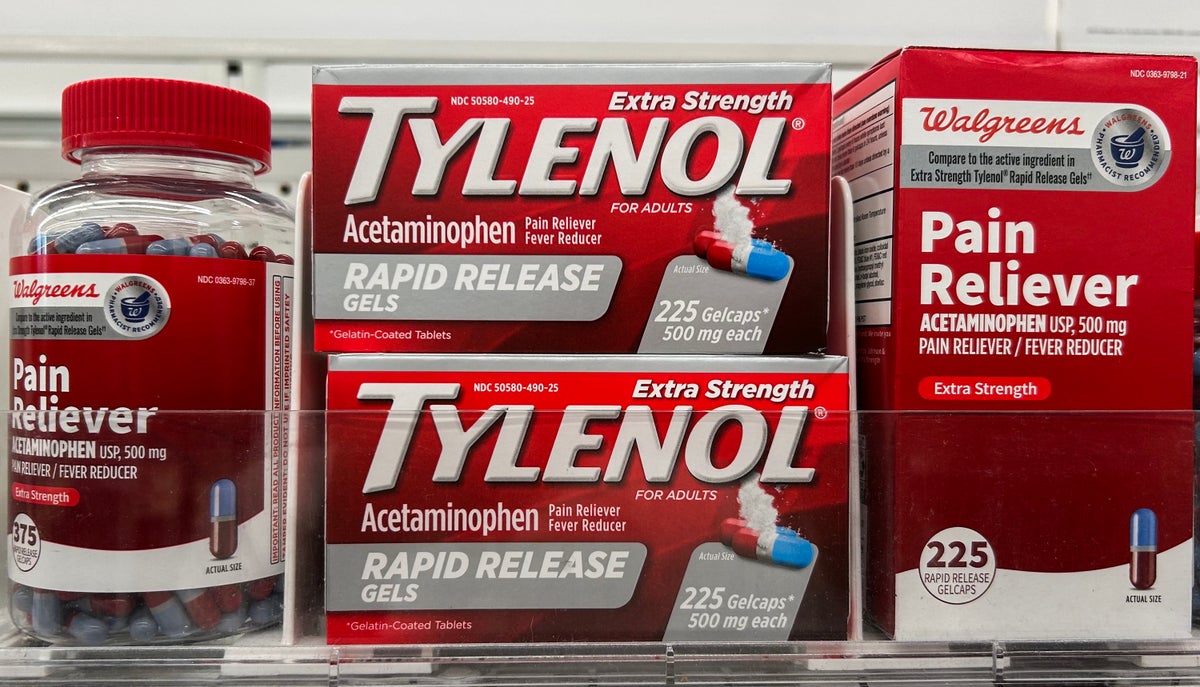 Two boxes marked Tylenol, a pill bottle and a generic box on a shelf.