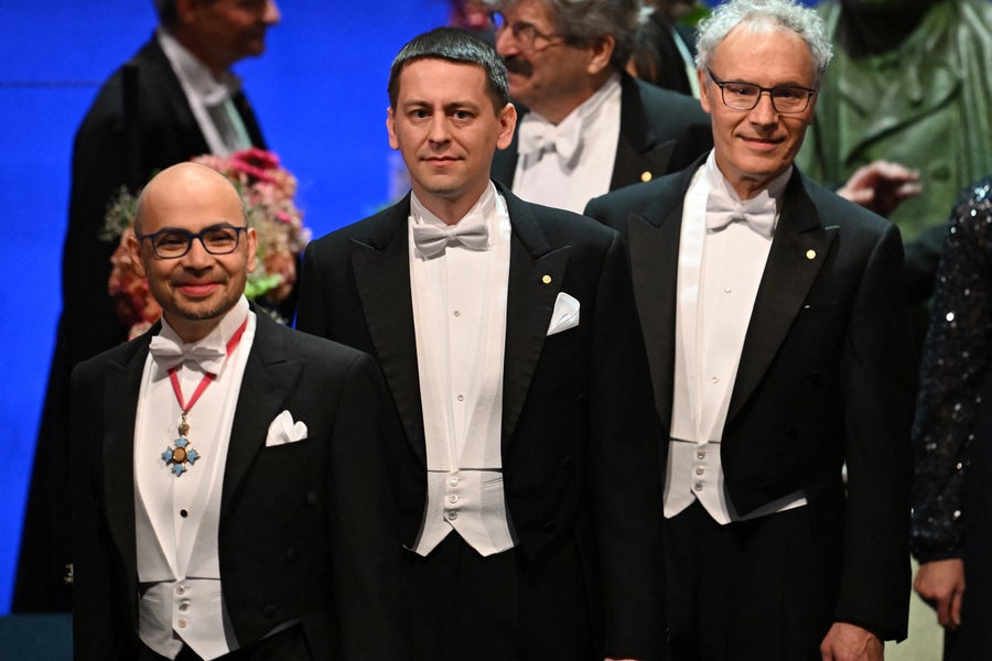 Demis Hassabis and John Jumper arrive on stage for the Nobel Prize award ceremony