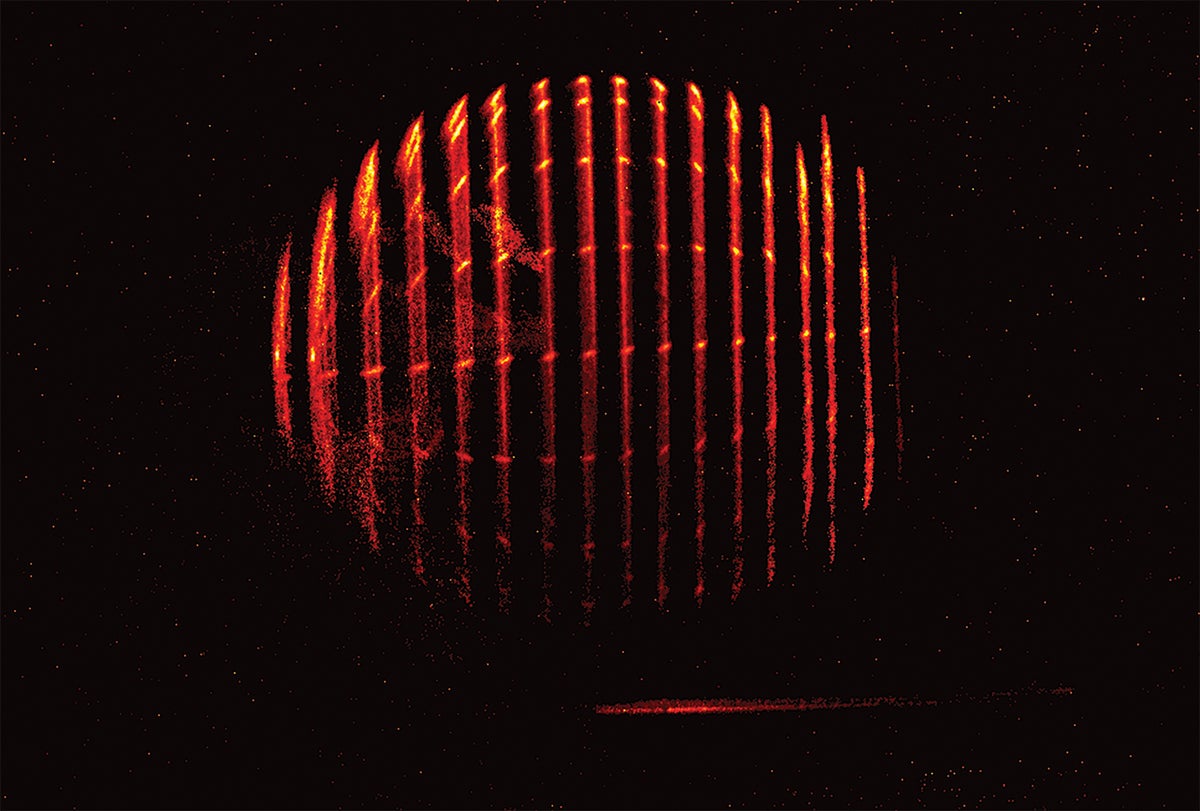 Video shows vertical slices of red light revealed in succession on a black background. A slightly elongated and rotated spherical shape emerges and then disappears.