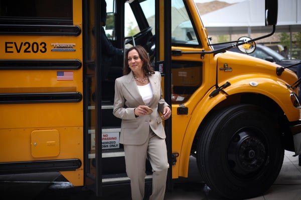 Vice President Kamala Harris walks off of an electric school bus.