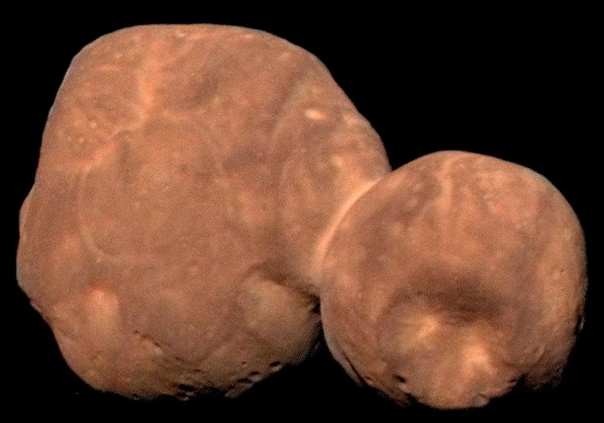 A smooth, reddish, asteroid composed of two spherical lobes joined by a narrow neck.