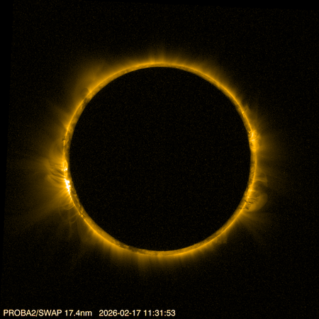 The sun's ring, shown in high resolution, peeks from behind a dark circle
