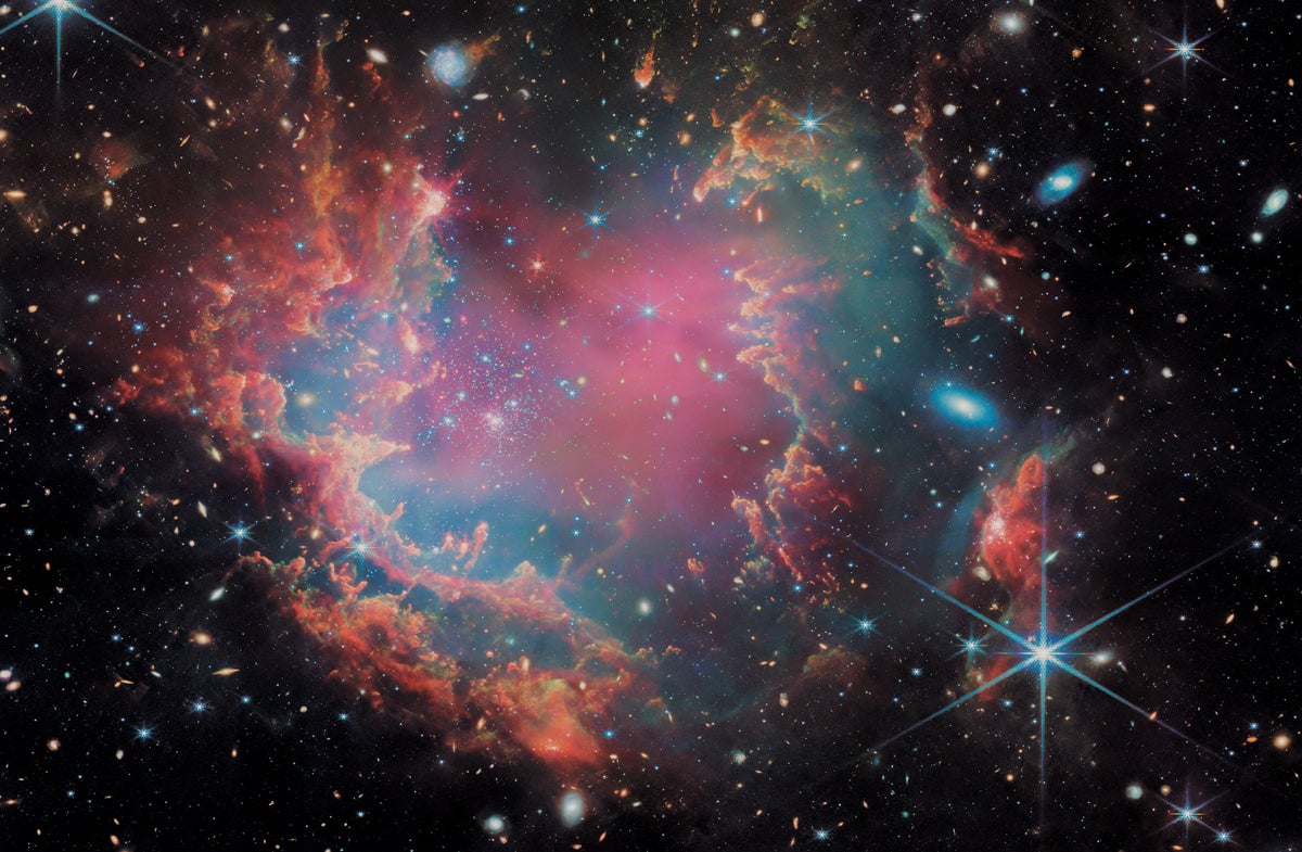 A JWST photograph shows the NGC 602 star cluster in the Small Magellanic Cloud.