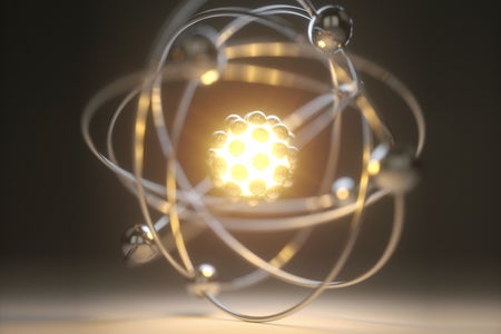 Conceptual illustration of an atom with nucleus glowing