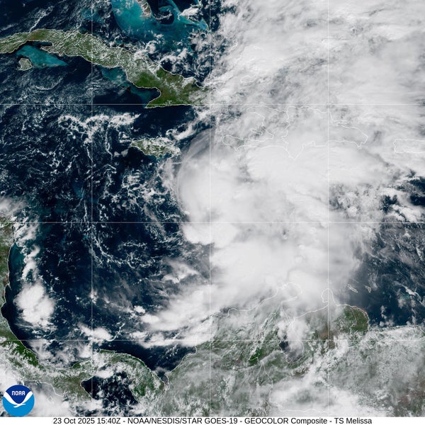 Swirl of white clouds seen over the background of the dark blue ocean and green and brown parts of South America, Jamaica and Cuba