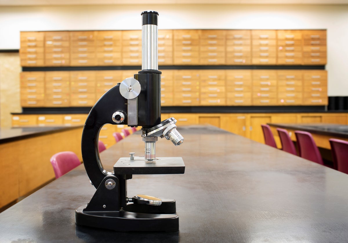 Microscope on desk of empty science classroom