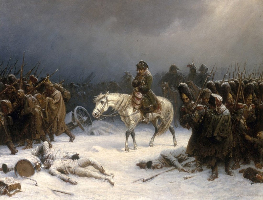A man on white horse trudges on a snowy field amid brown robed downcast soldiers.