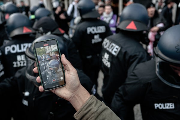 Protesters filming police at a protest in Germany