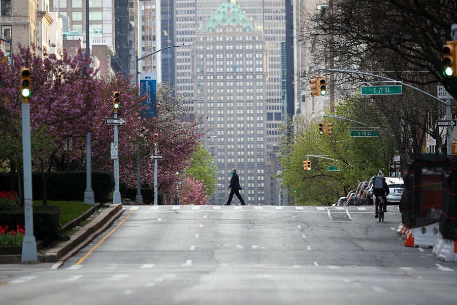 A man crosses the empty streets of New York City in the early days of the COVID lockdown.