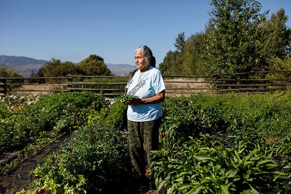 A woman standing in a garden.
