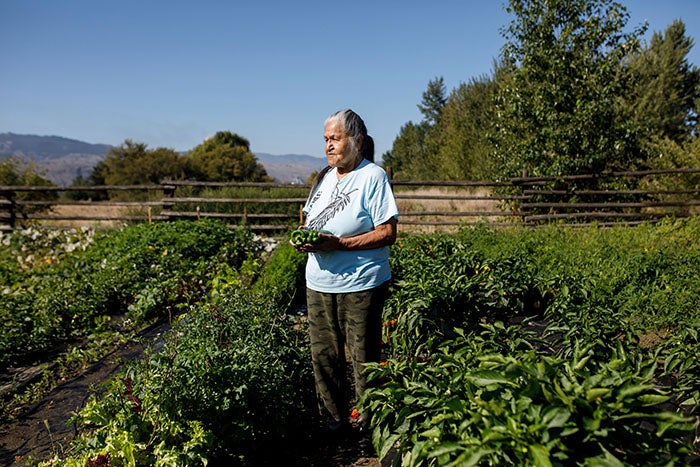 A woman standing in a garden.