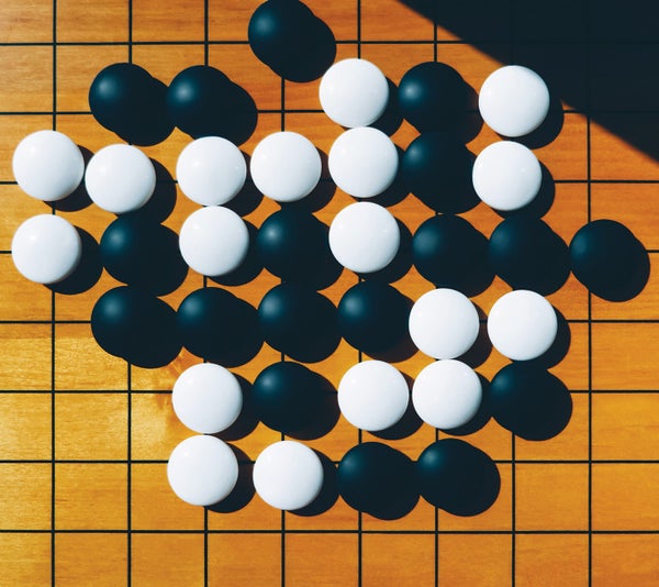 A board game with black and white balls.