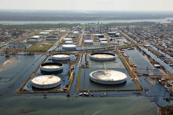 Flooded storage tanks are pictured on the grounds of a refinery