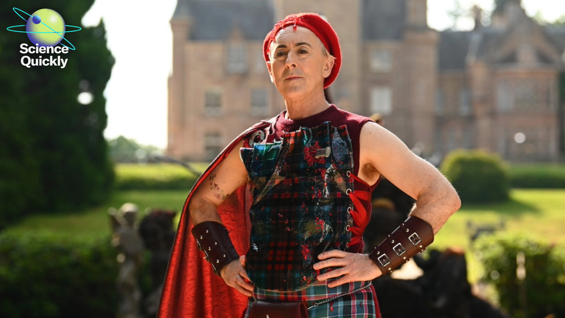 An image of a man standing outside of a castle with his arms on his waist