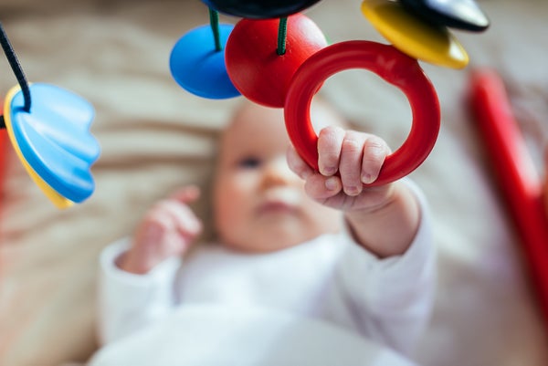 Baby playing with hanging mobile
