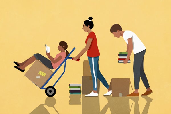 3 people reading, packing and moving boxes of books with hand truck