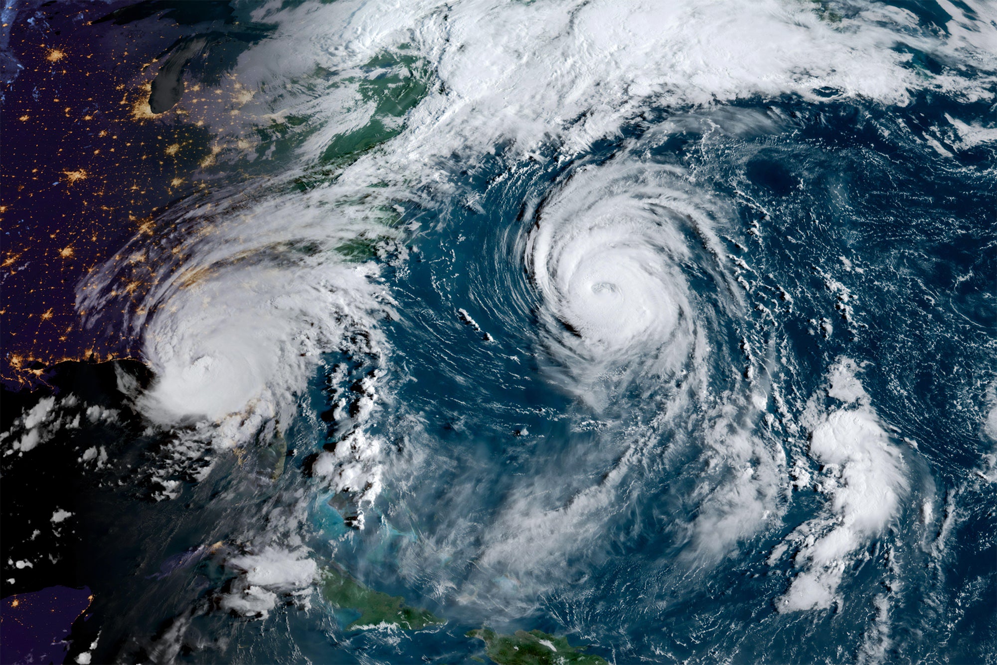 Early morning satellite image of the eastern coast of the United States and the Atlantic Ocean. Hurricane Idalia on the left makes landfall on Florida's coast and Hurricane Franklin sits over the Atlantic near Bermuda