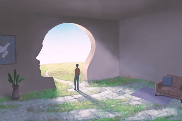 Conceptual illustration of a person standing in a room with a couch and decor looking out of a passageway in the shape of a human head leading outside