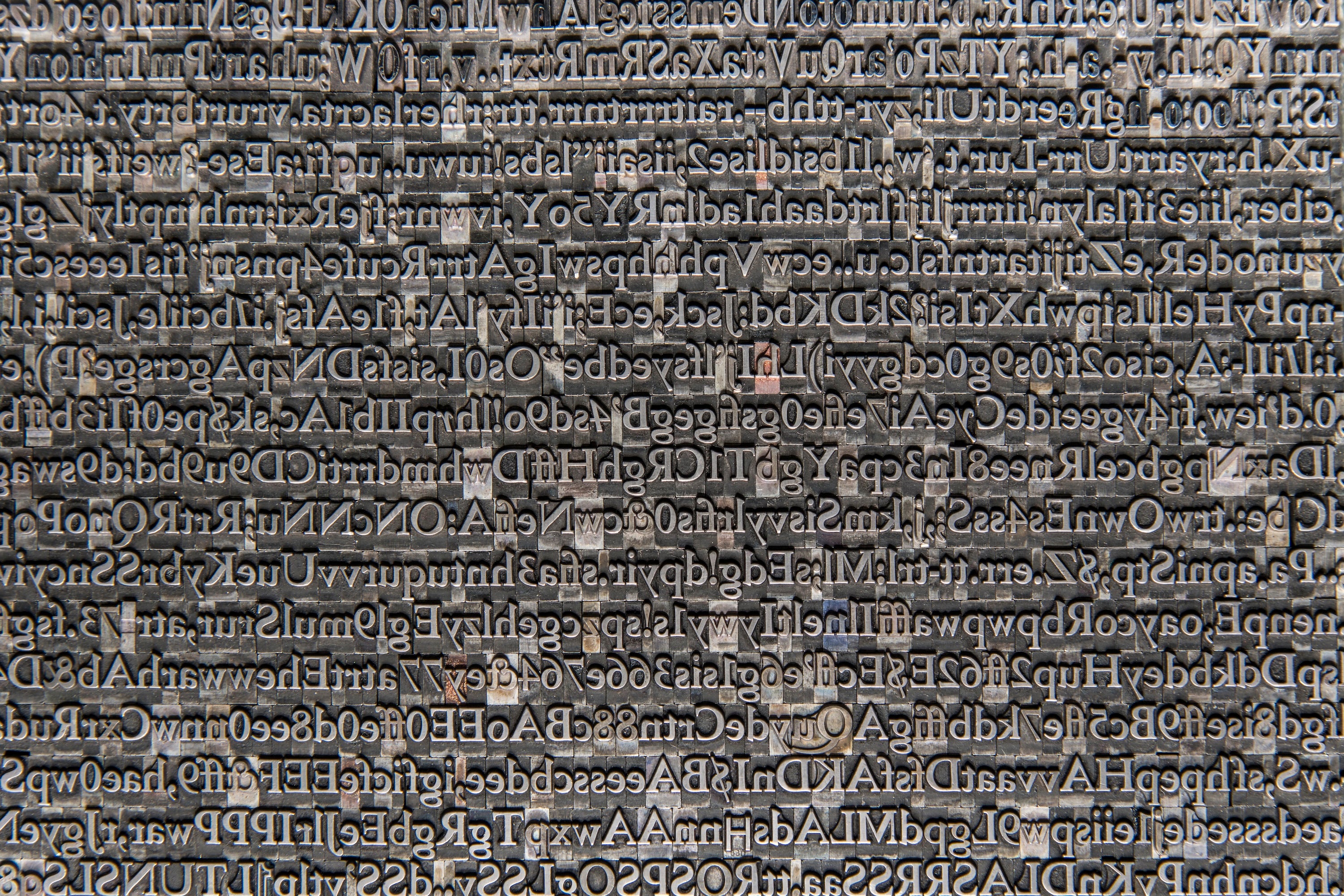 A photograph of moveable type in which the letters are lined up without any order.