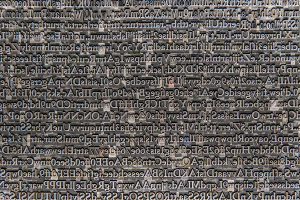 A photograph of moveable type in which the letters are lined up without any order.