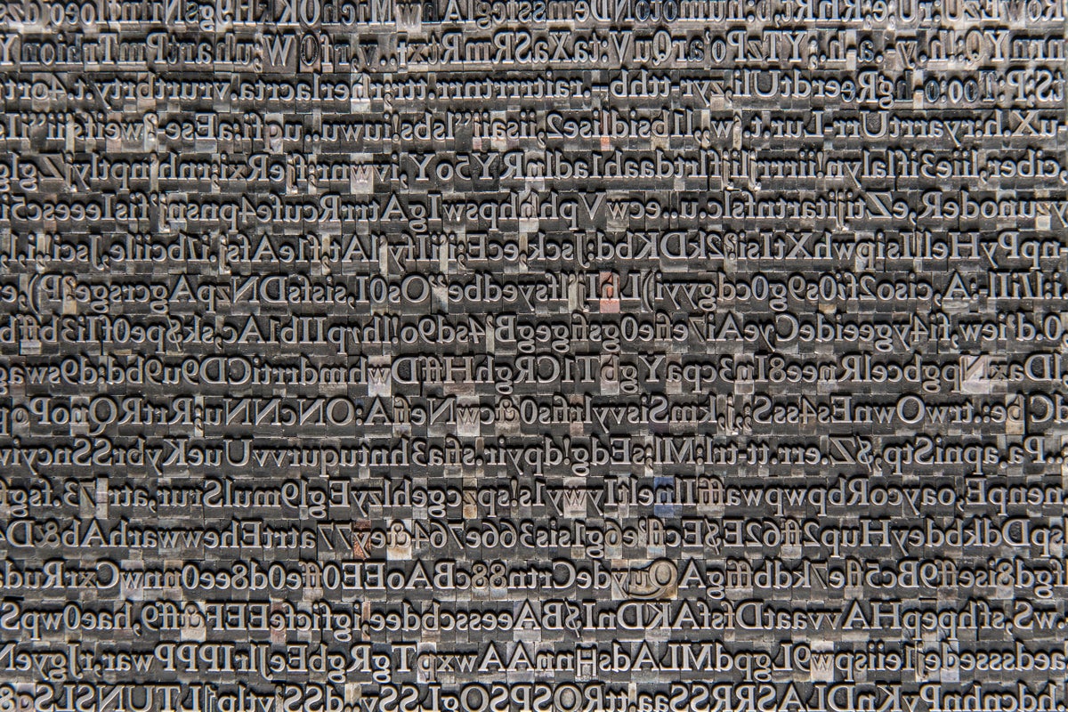 A photograph of moveable type in which the letters are lined up without any order.