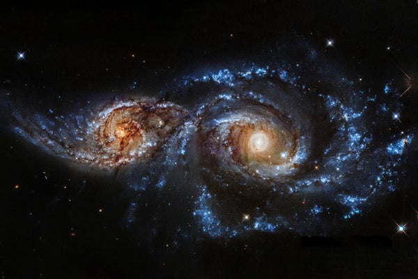 Two colliding spiral galaxies are on the cusp of merging into an intermingled swirl of stars.