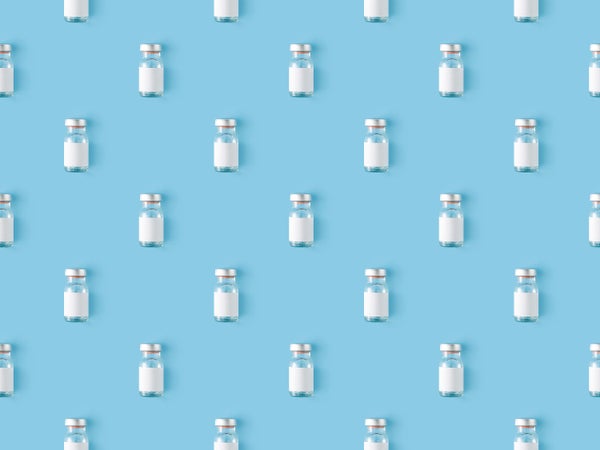 Seamless repetitive vaccine bottle on a blue background
