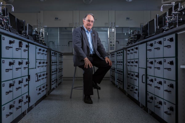 M. Stanley Whittingham sitting in a lab
