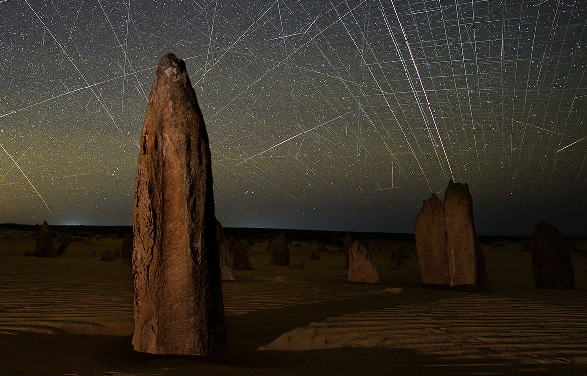 Satellite streaks appear in a photograph taken above the Pinnacles in Nambung National Park, Western Australia.