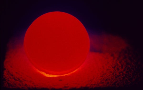 A pellet of plutonium, illuminated by the glow of its own radioactivity