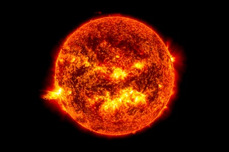 Image from June 20, 2013, at 11:15 p.m. EDT shows the bright light of a solar flare on the left side of the sun and an eruption of solar material shooting through the sun’s atmosphere, called a prominence eruption