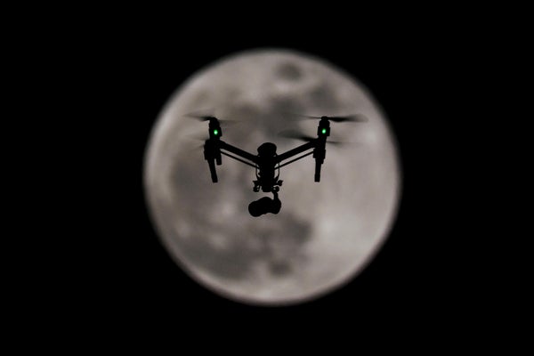 Drone in front of full moon.