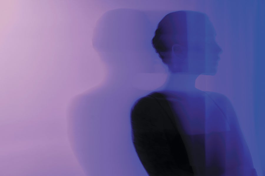 Silhouette of a woman against a purple background